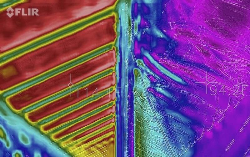 FLIR thermal image of an attic: the hot side reads 114°F in red, the cool side reads 94°F in purple — a 20°F differential across the same attic.